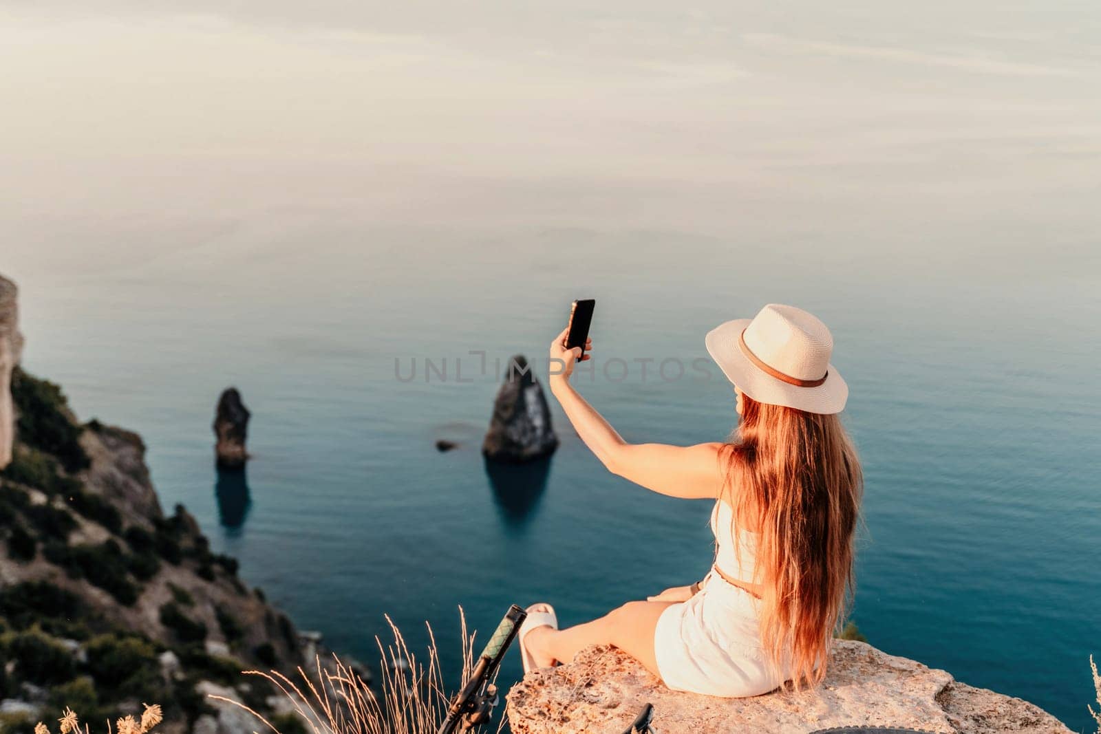 Selfie woman in cap and tank top making selfie shot mobile phone post photo social network outdoors on sea background beach people vacation lifestyle travel concept. by Matiunina