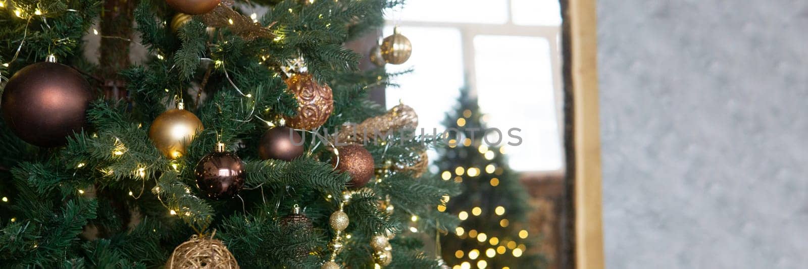 Bronze balls on the Christmas tree close-up. Christmas tree design decorations. The concept of celebrating New Year and Christmas