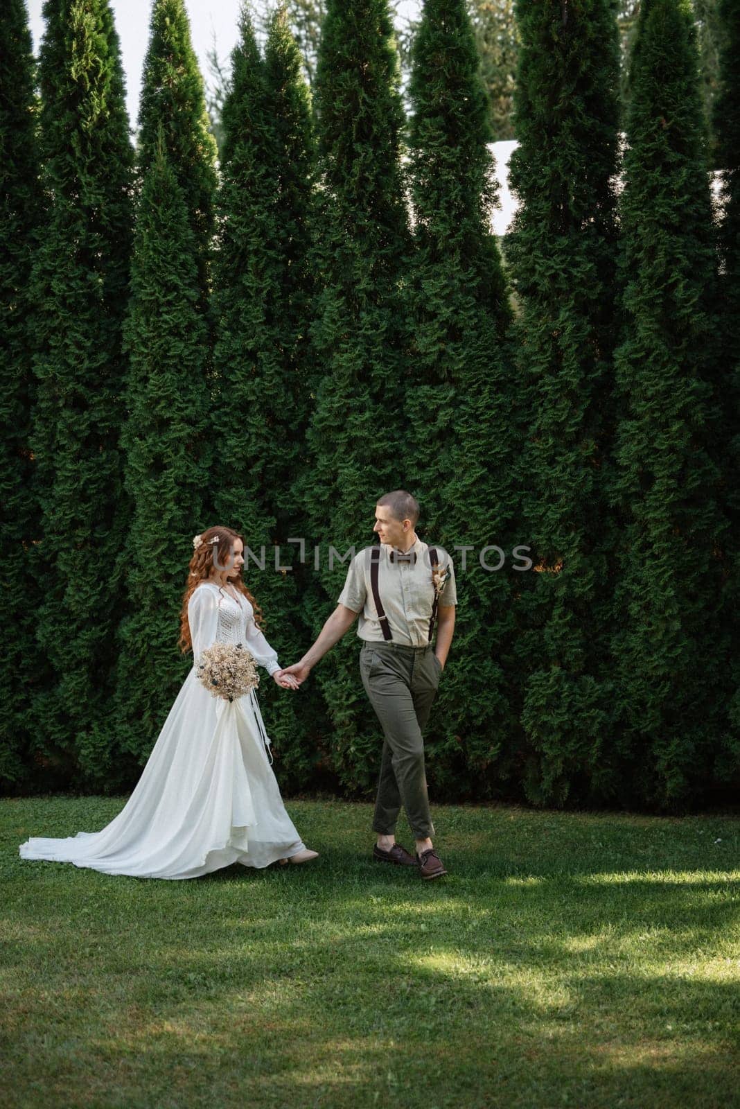 wedding walk of the bride and groom in a coniferous by Andreua