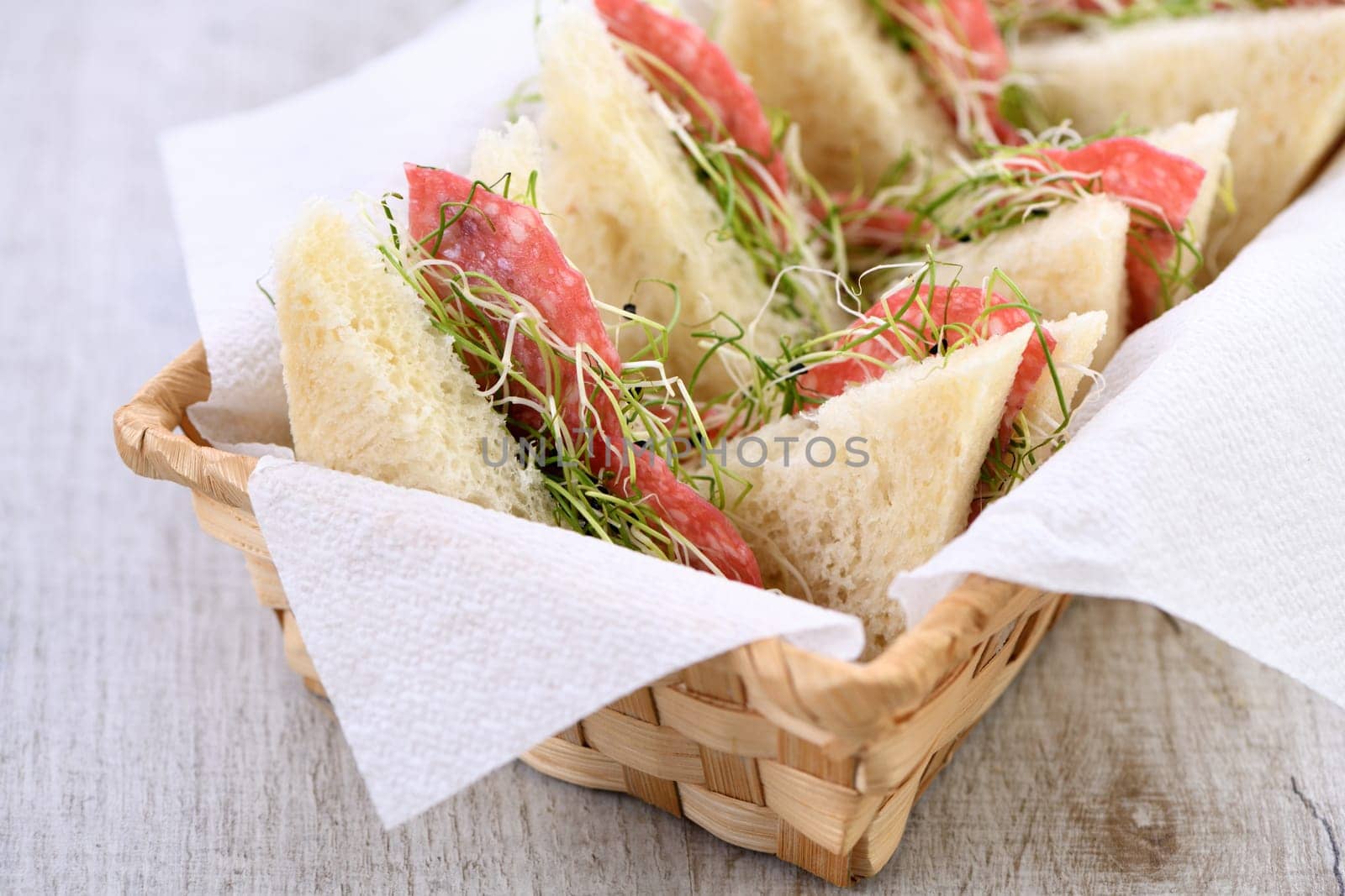 Wheat toast sandwich with cream cheese with microgreen alfalfa sprouts and salami. Healthy and fresh food.