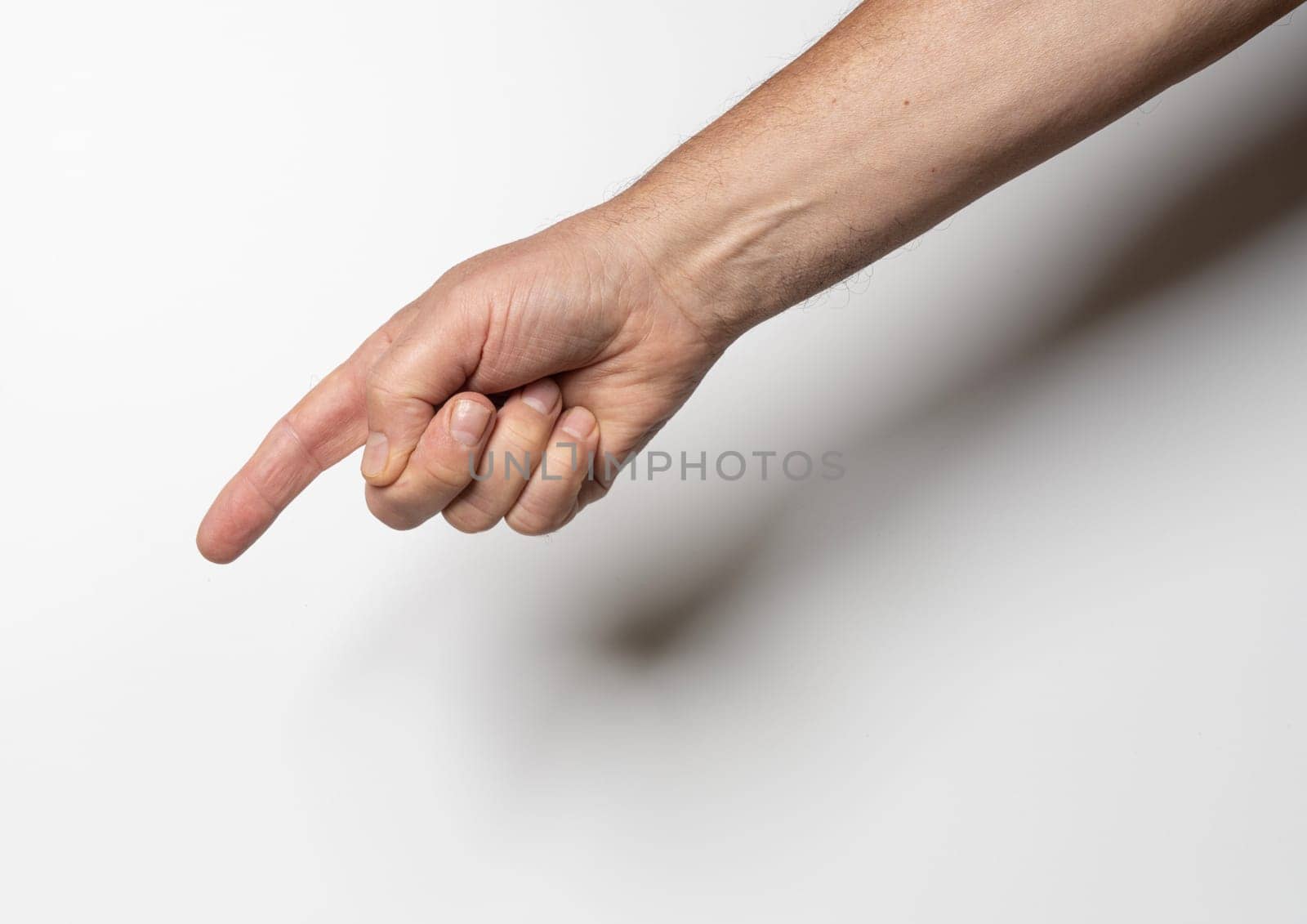 a male hand pointing with a finger on a white background