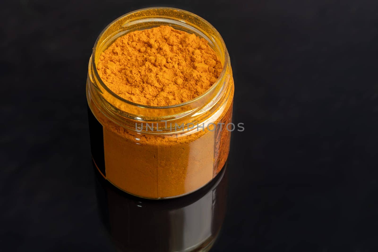 Variety of spices on a dark background in a glass bowl. Enhancement of taste. copy space