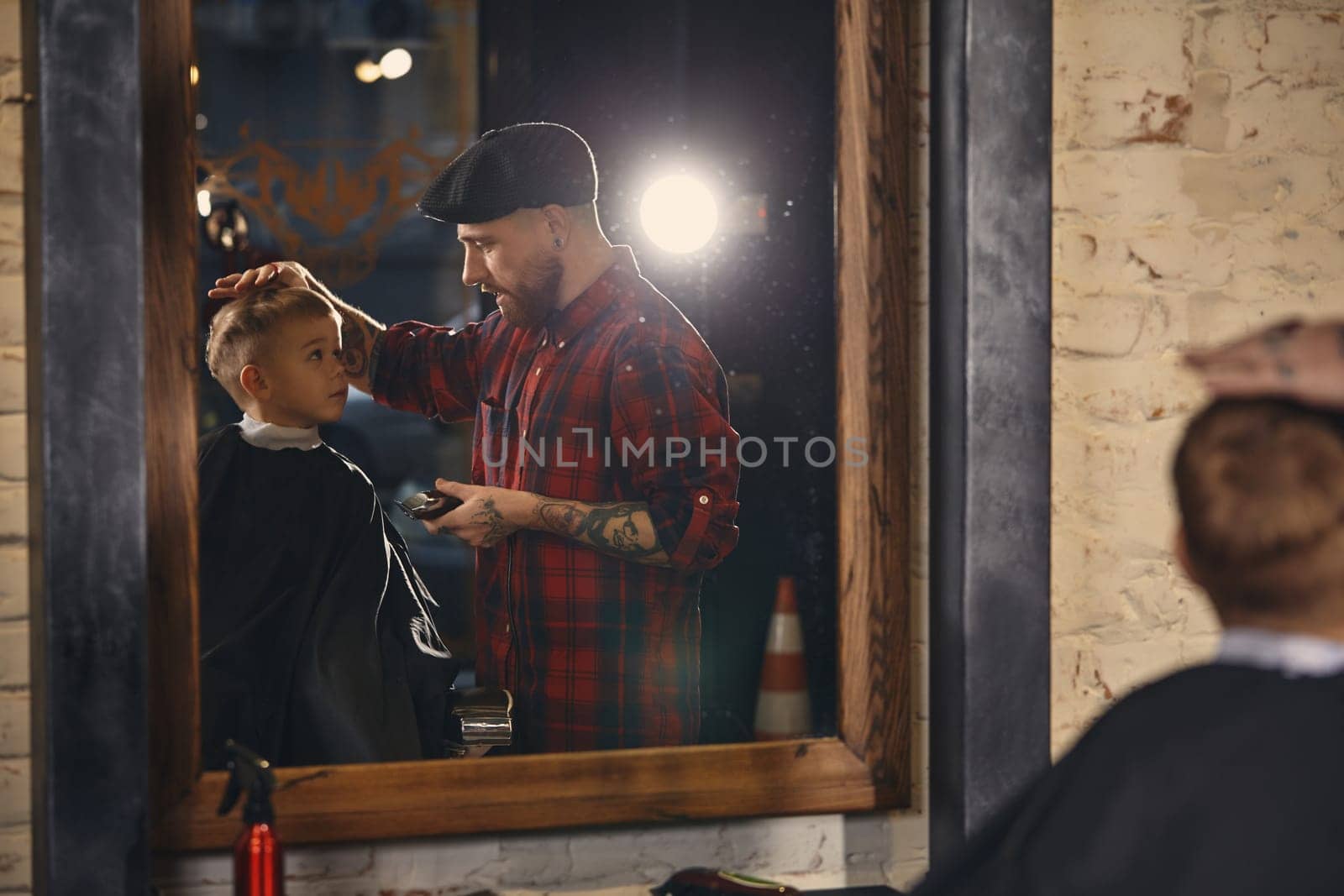 Caucasian boy getting haircut in barbershop indoor by nazarovsergey