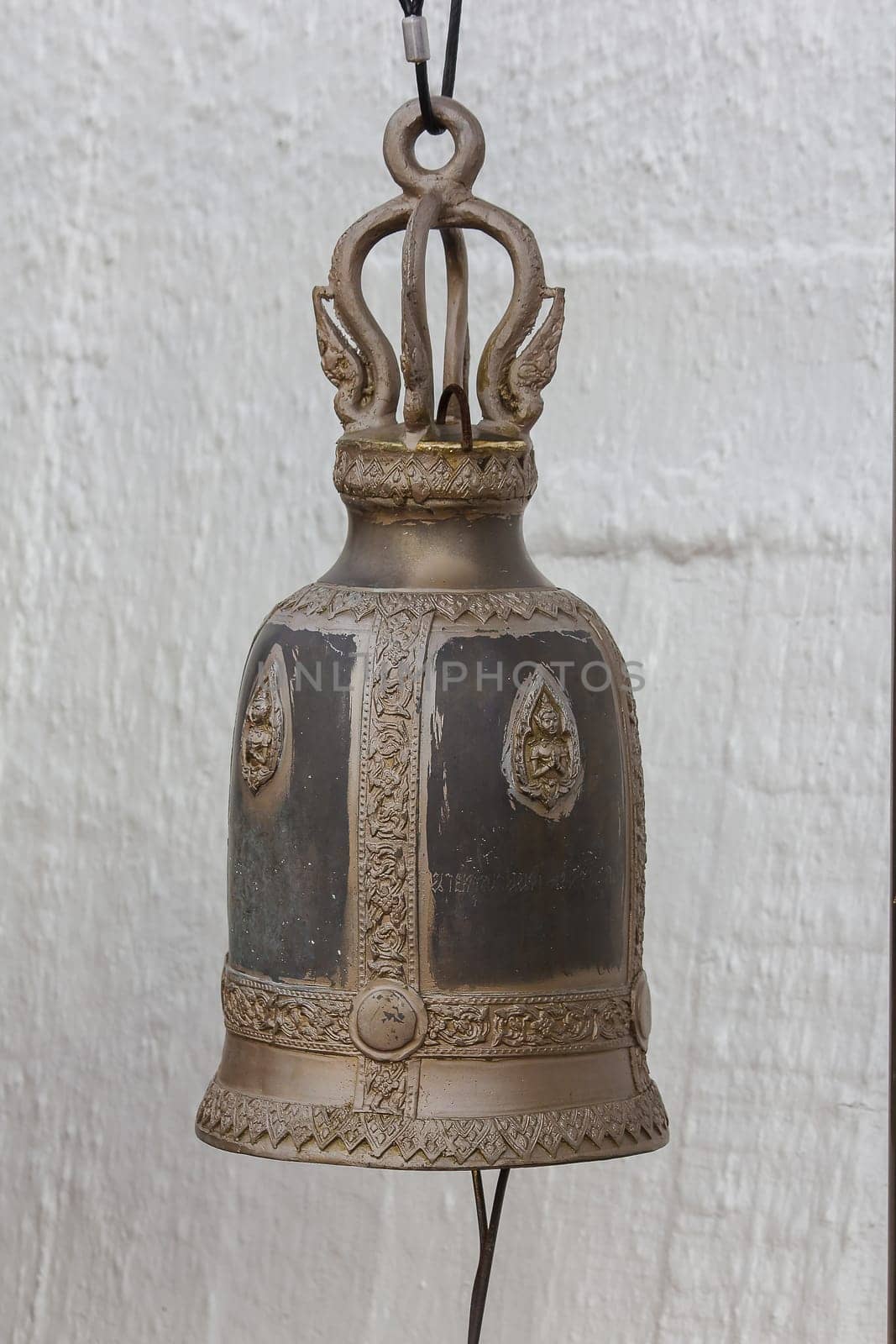 Big brass bells are commonly hung in Thai temples.