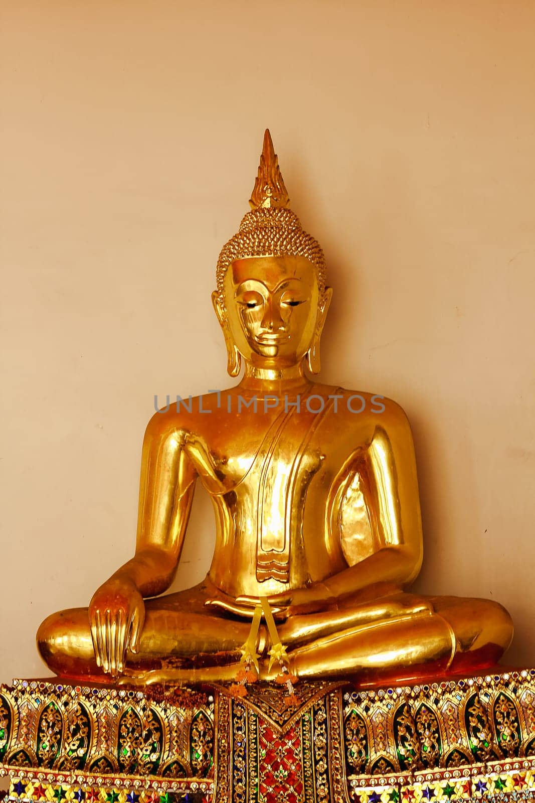 Beautiful golden Buddha On the pedestal, some white walls