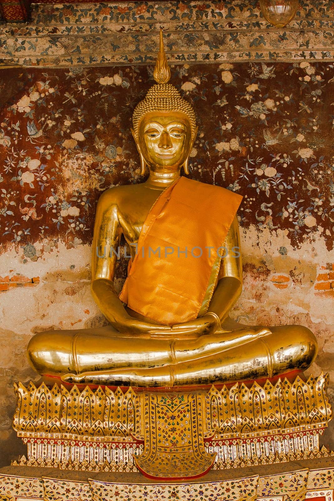 Golden Buddha beside old walls in Thai temples