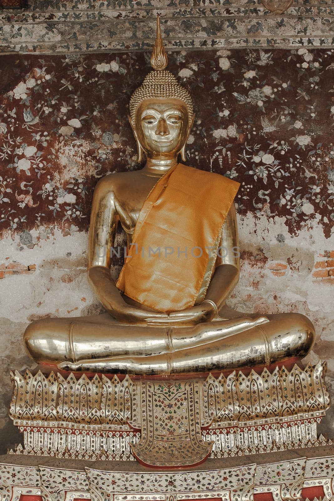 Golden Buddha beside old walls in Thai temples