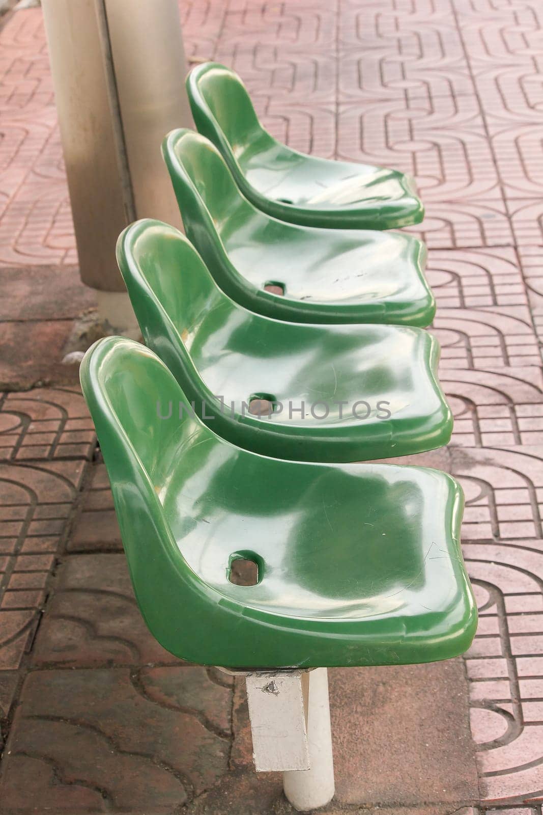 Green plastic chair at the bus stop For passengers waiting