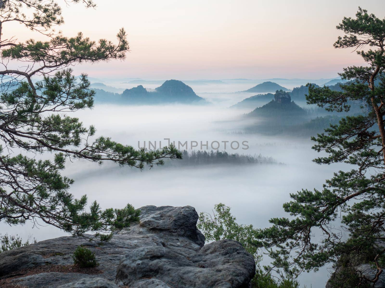 The fabulous vistas of Saxon Switzerland.  Kleiner Winterberg view, beautiful morning view over sandstone cliff into deep misty valley.