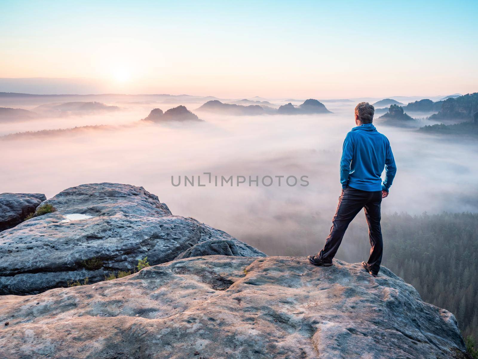 Lone man hiker relaxing on the mountain and watching sunset  by rdonar2