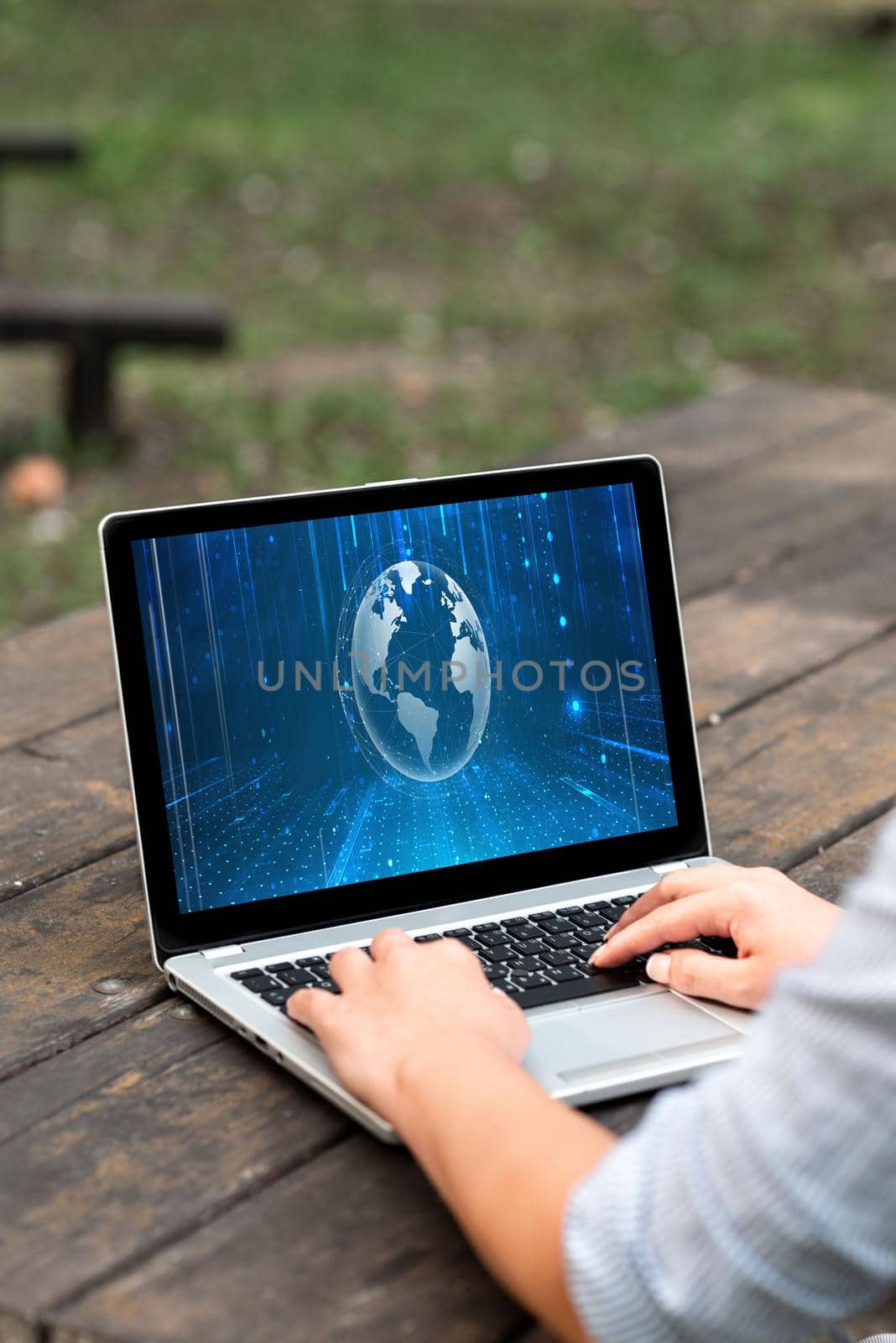 Laptop Placed Resting On Table Working In The Park Actively Accomplishing Remote Jobs. Minicomputer Settled At Top Of Desk Outdoors Busy Doing Computer Works. by nialowwa