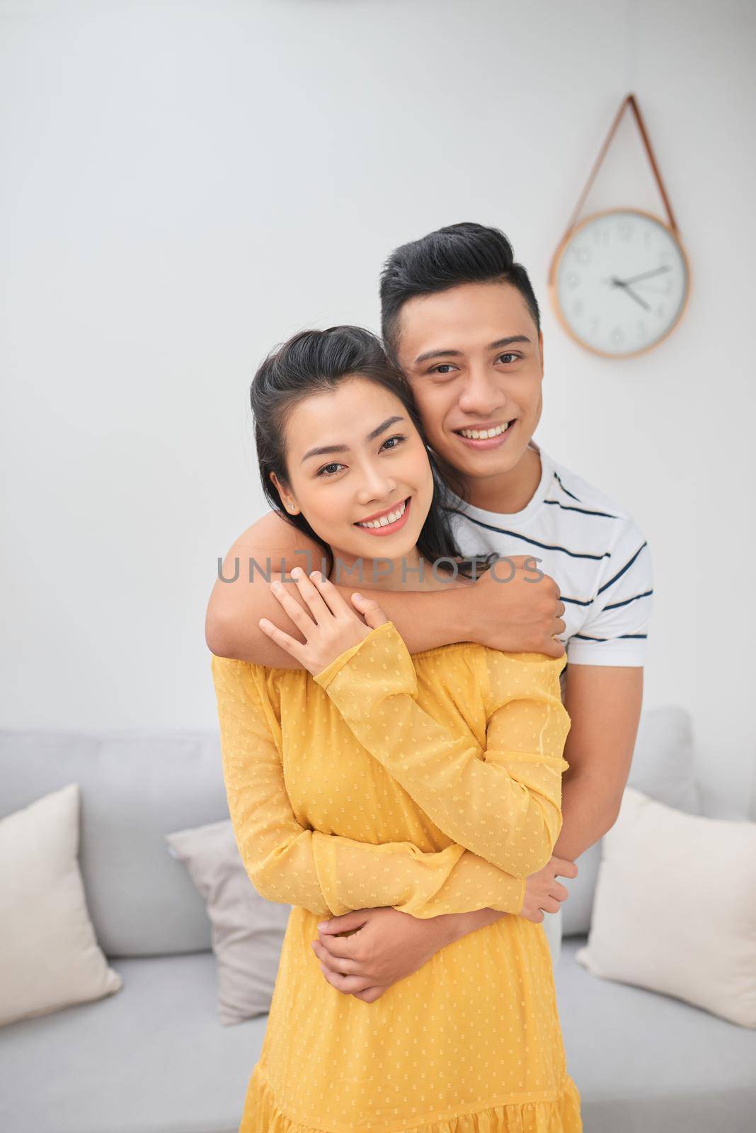 Romantic young couple embracing in living room