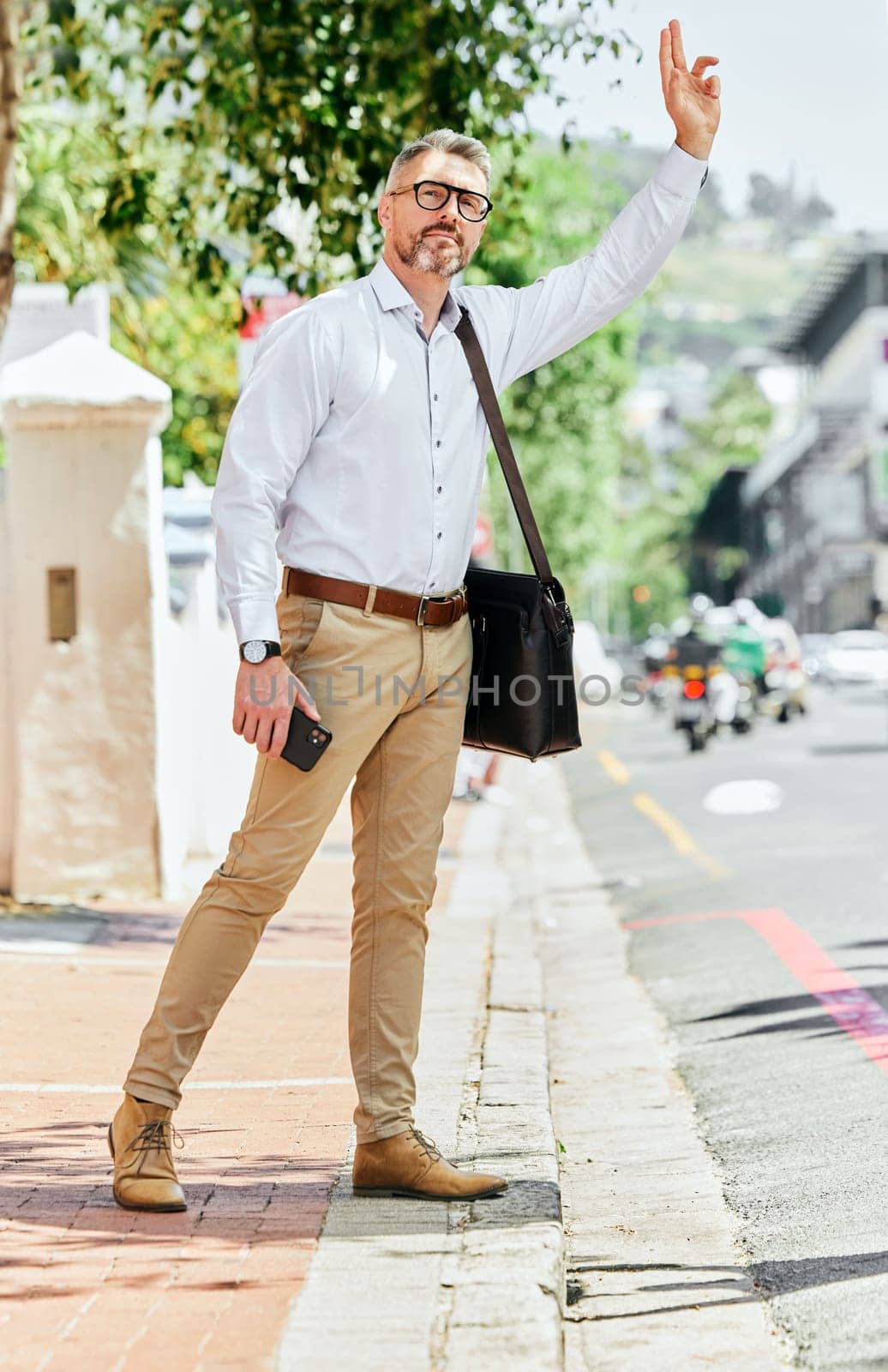 Businessman, travel or stop for taxi in city, commute and trip to work on road with phone. Mature person, employee or entrepreneur wave, hailing or transportation service hand gesture with technology.