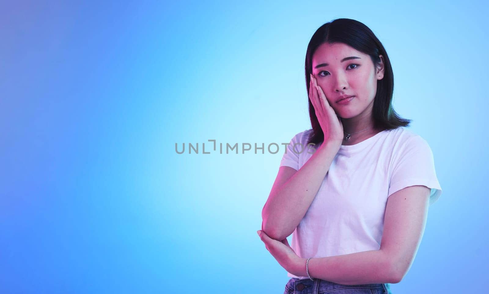 Mockup, neon and portrait of Asian woman in studio for information, promotion and deal on blue background. Creative lighting, marketing and isolated person with space for news, announcement and sale by YuriArcurs