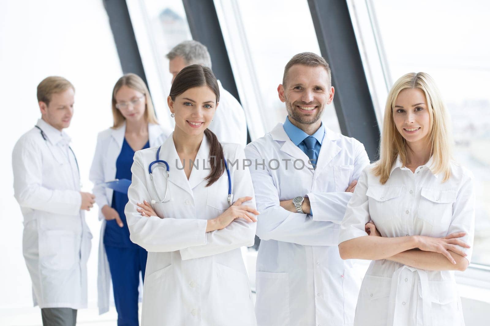 Successful team of medical doctors are looking at camera