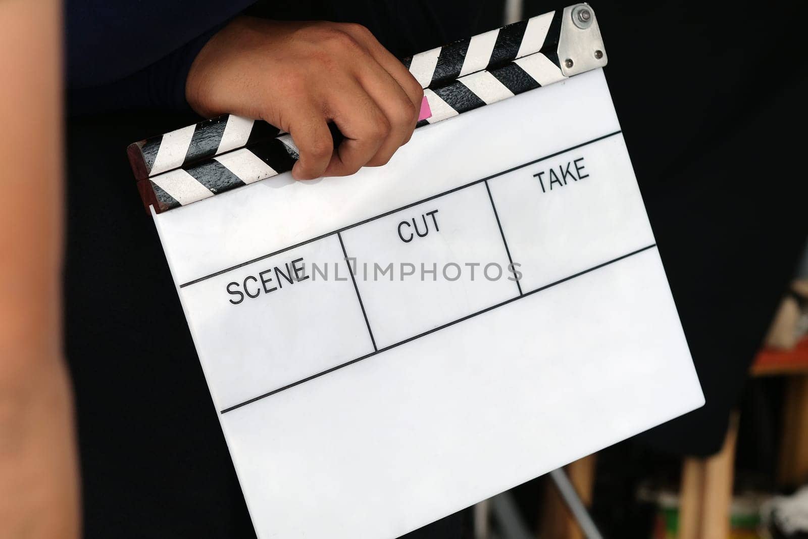 film production crew holding Film Slate on set by ponsulak