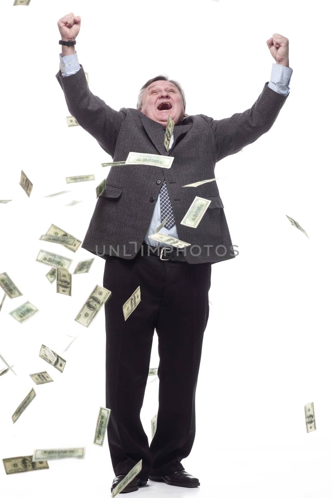 in full growth.happy entrepreneur with banknotes. isolated on a white background.