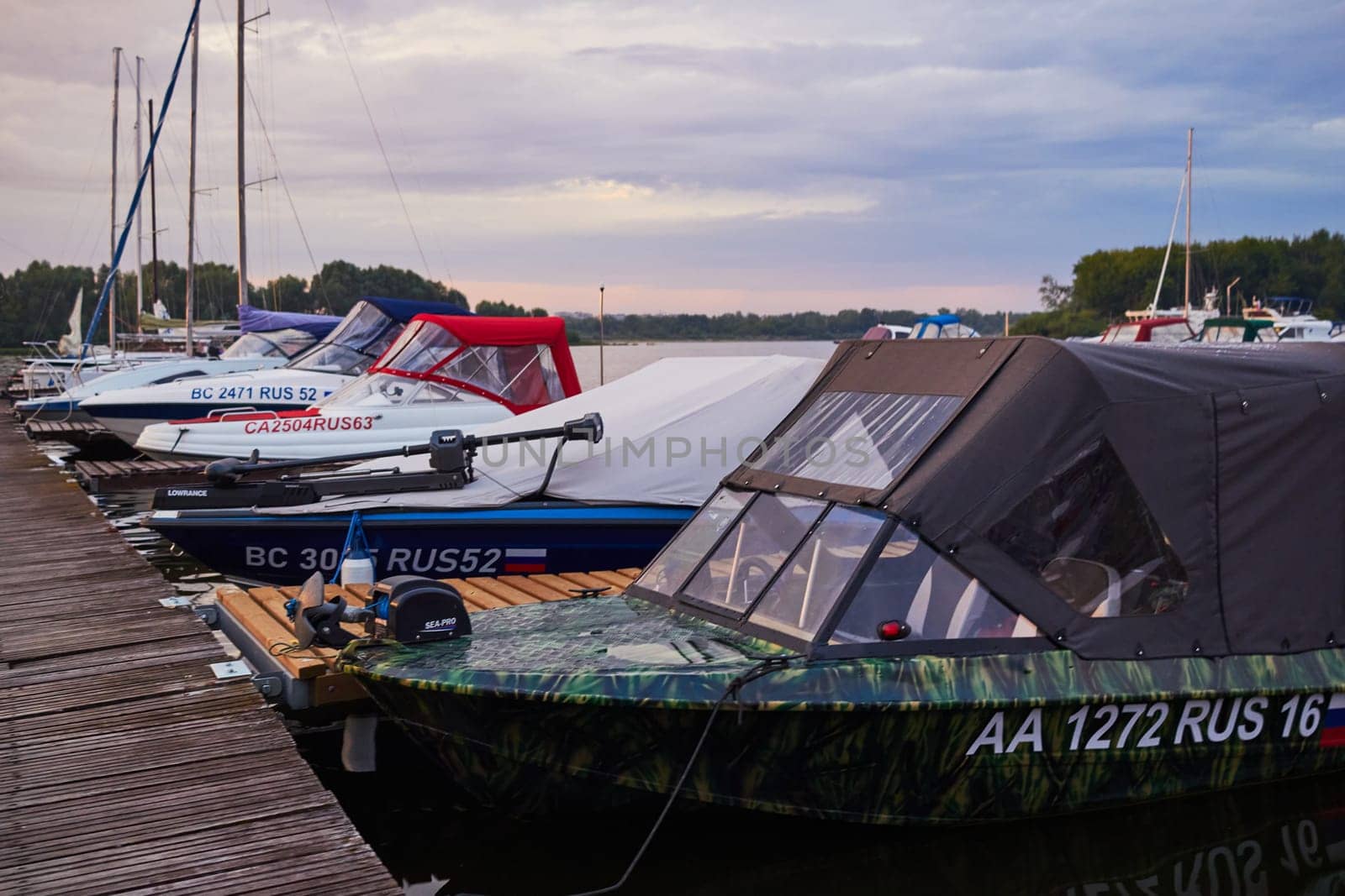 Photo of boat parked near wooden bridge. by electrovenik