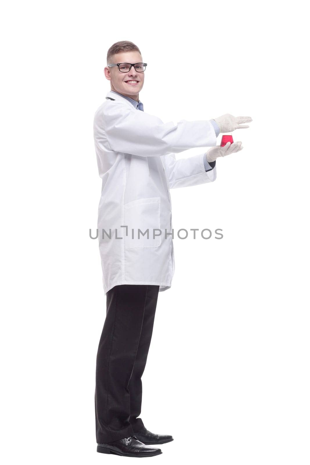 in full growth. smiling doctor with a laboratory flask. isolated on a white background.