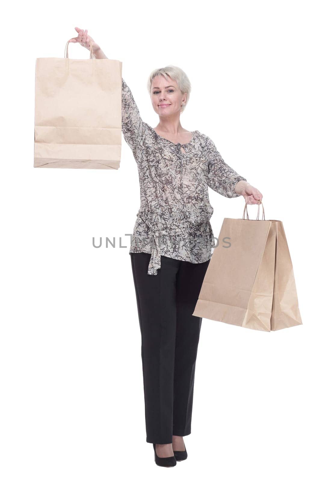 in full growth. elegant young woman with shopping bags . isolated on a white background.