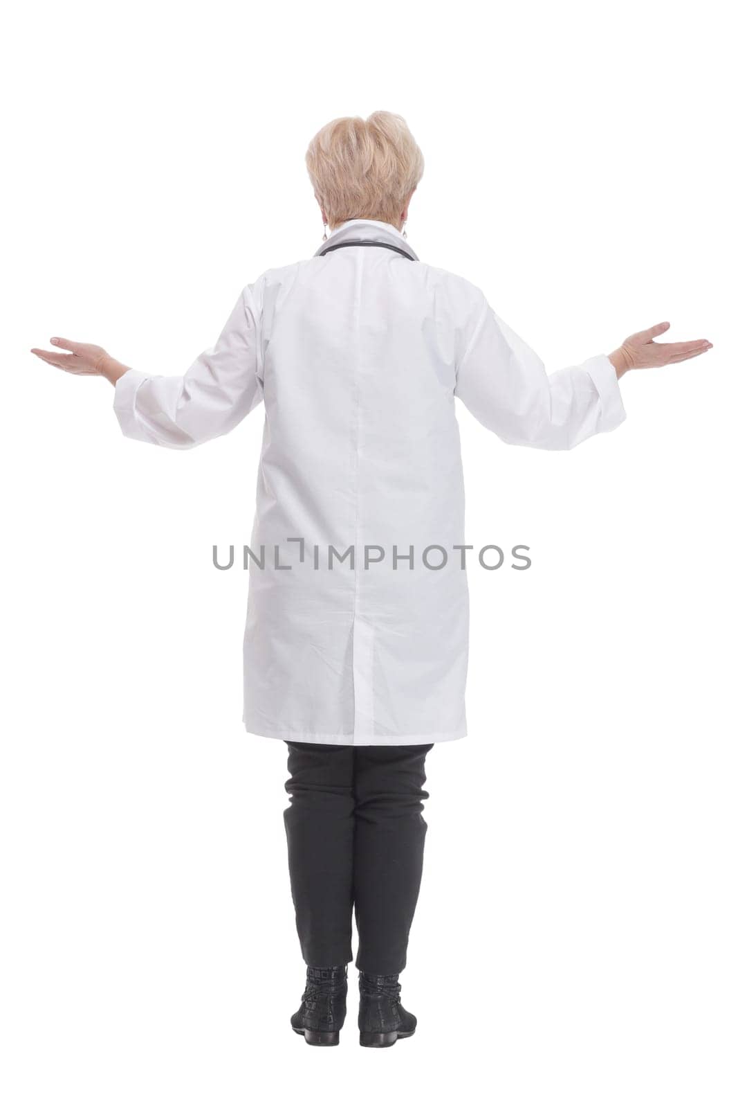 in full growth. competent doctor in a white coat. isolated on a white background.