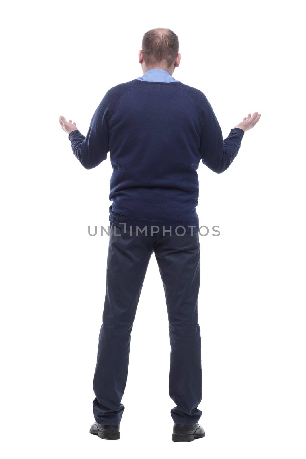 back view. mature man in blue jumper. isolated on a white background.