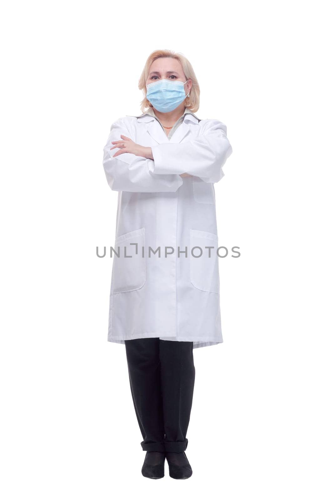 Confident woman doctor wearing medical mask standing with crossed arms. isolated female portrait.
