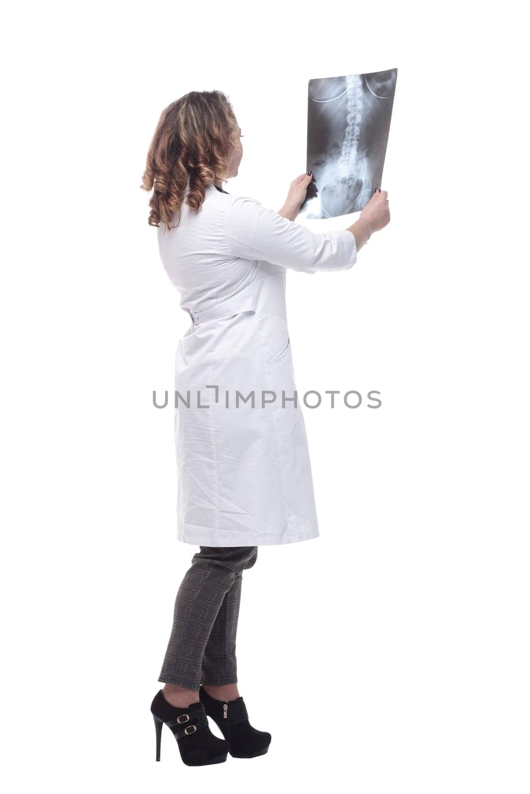 young female doctor looking at an x-ray. isolated on a white background.