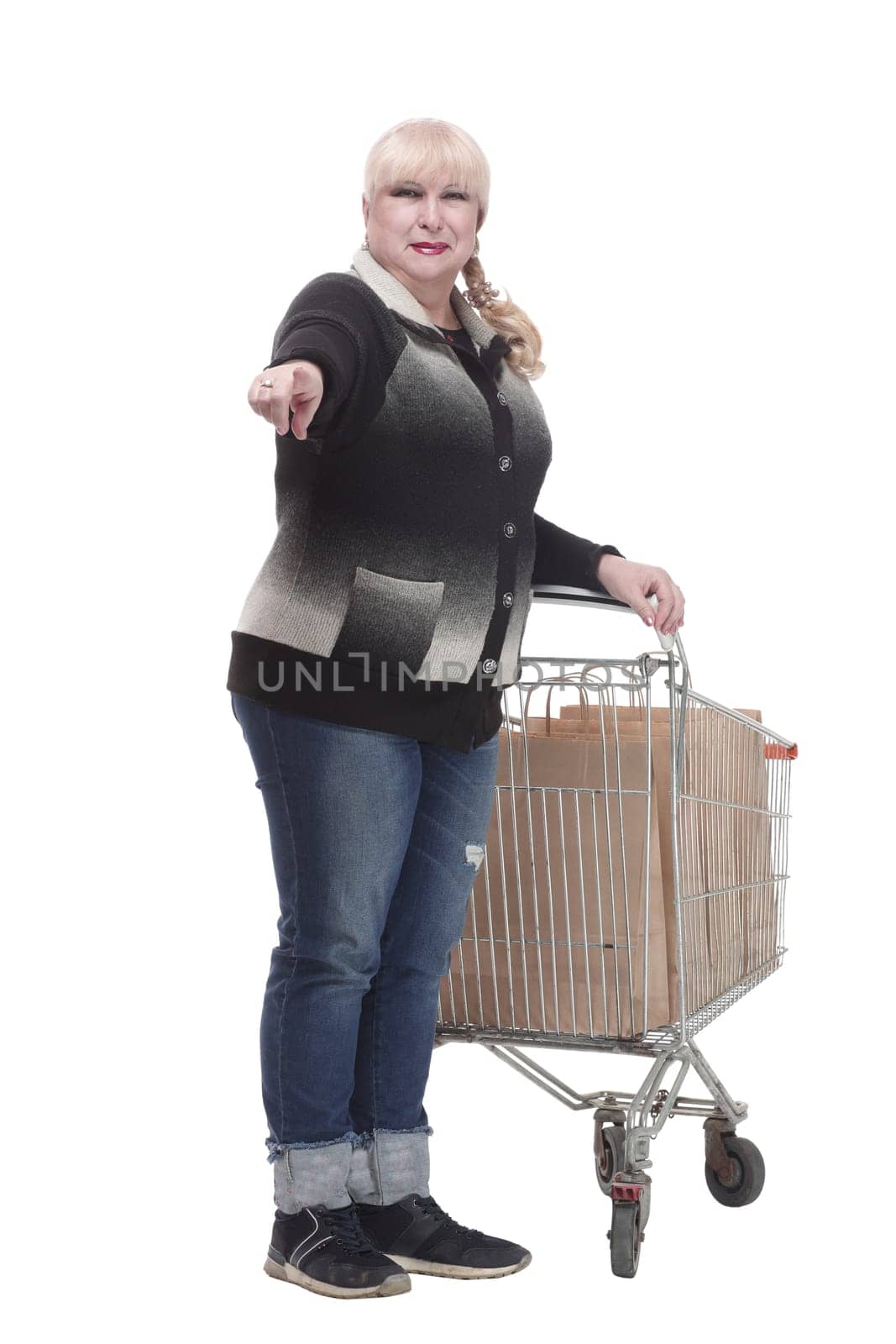 full-length. casual woman in jeans with shopping cart. isolated on a white background.