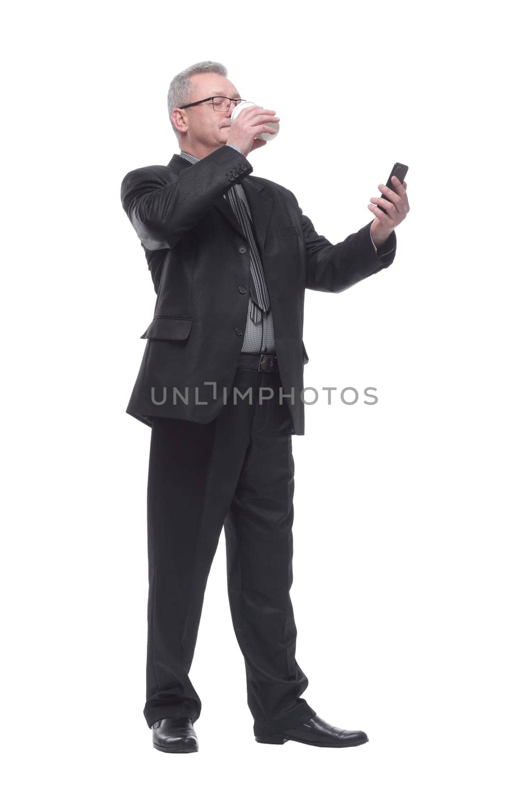 Business man with smartphone drink coffee and looking at camera and smiling to you