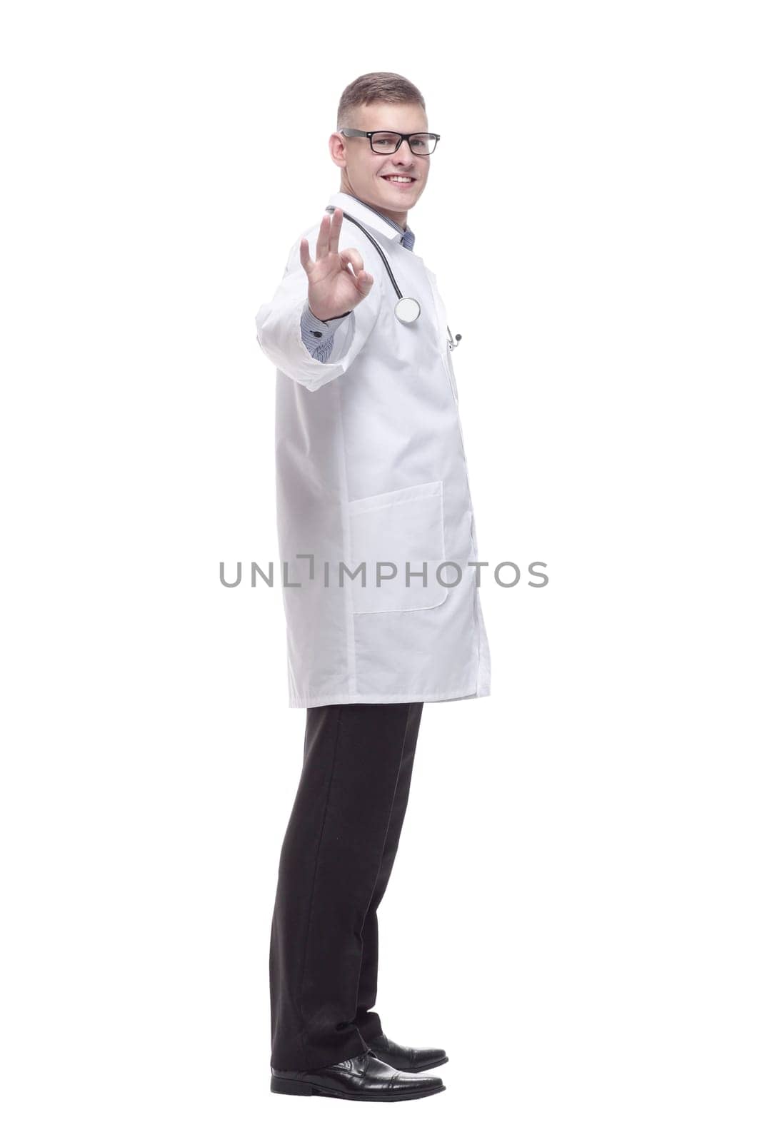 in full growth. confident young doctor with a stethoscope. isolated on a white background.