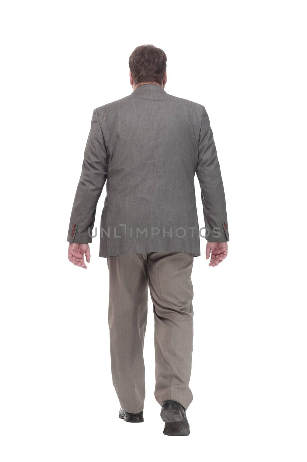 full-length. casual man in a grey jacket striding forward. isolated on a white background.