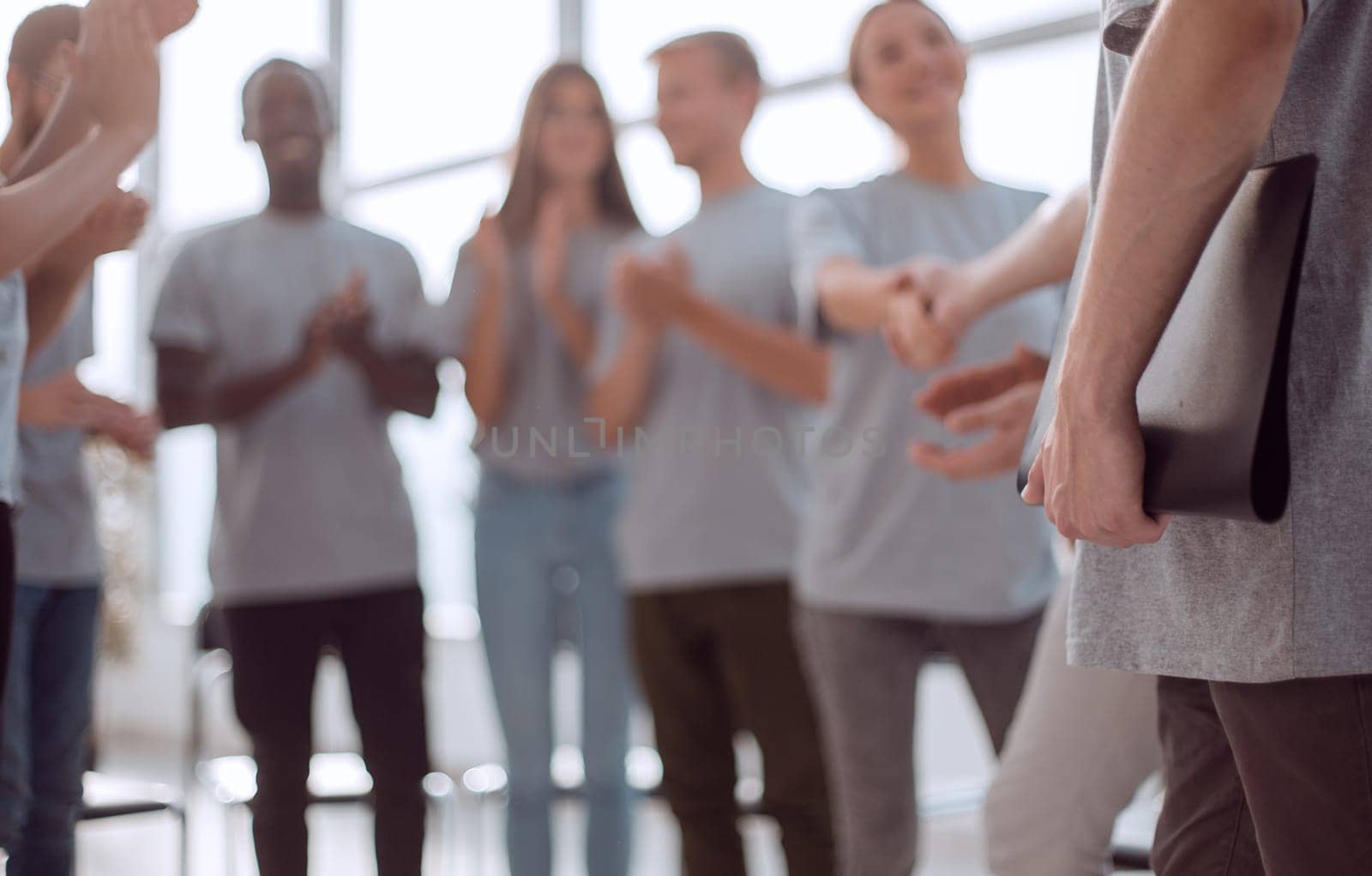 blurred image of a group of young people sitting in a circle. photo with copy space