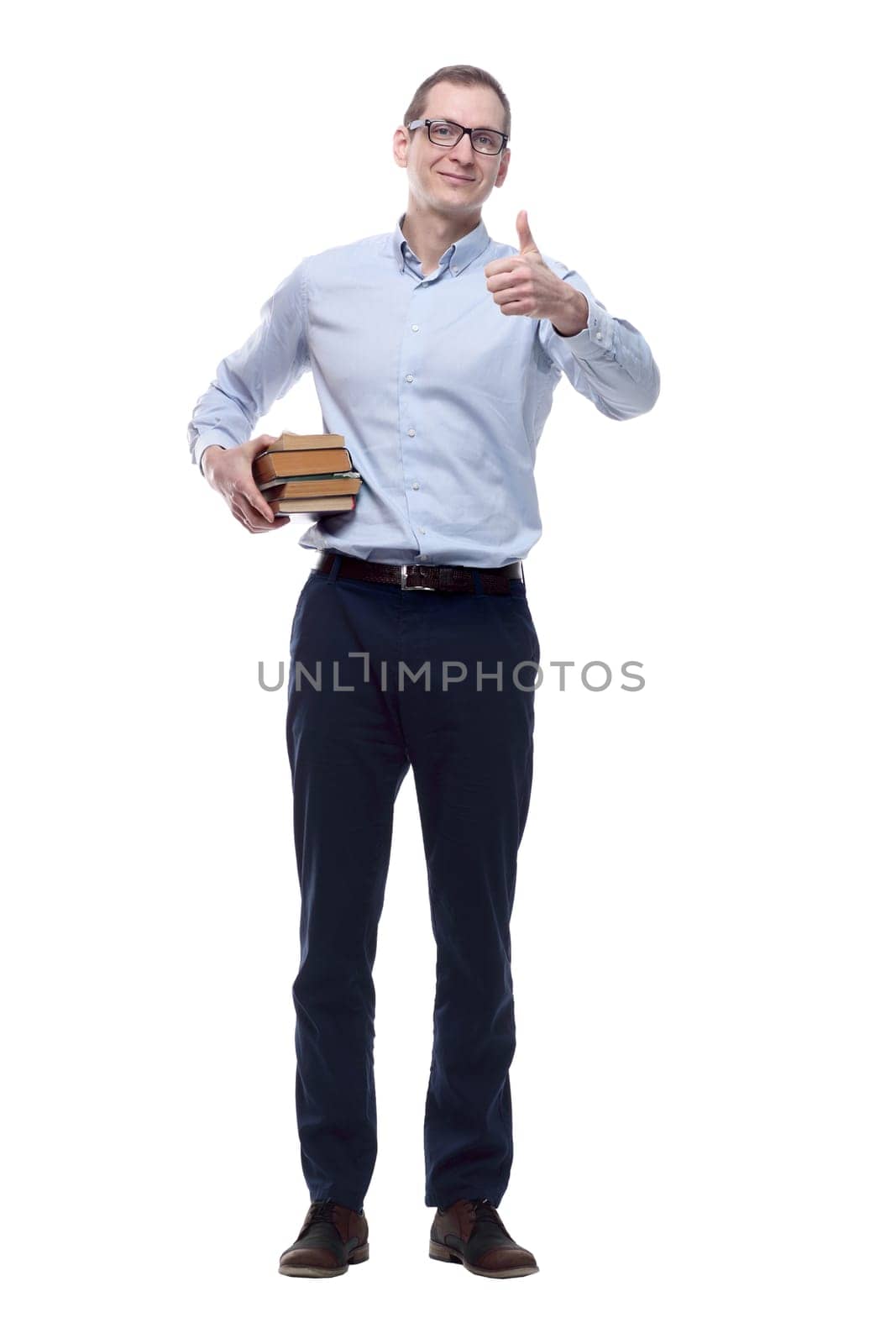 in full growth. a confident man with a stack of books pointing at you. isolated on a white