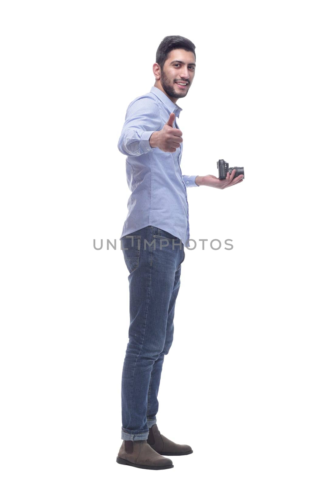 side view. male photographer with a camera. isolated on a white background.