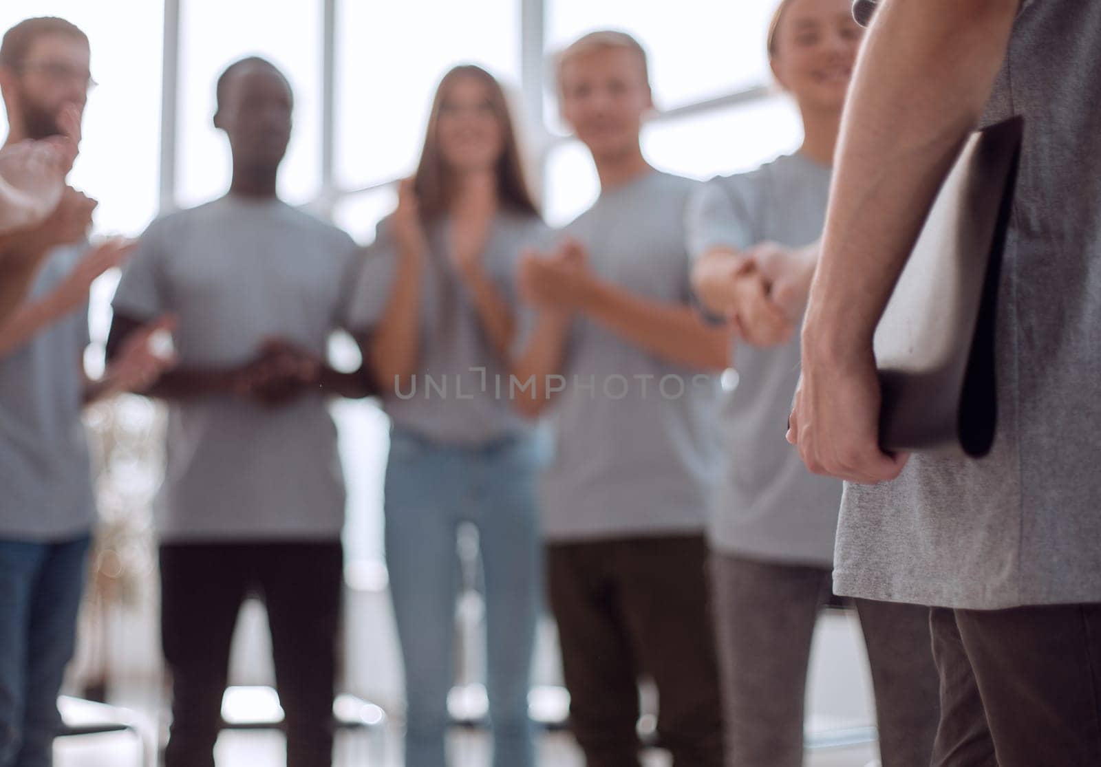 blurred image of a group of young people sitting in a circle. photo with copy space