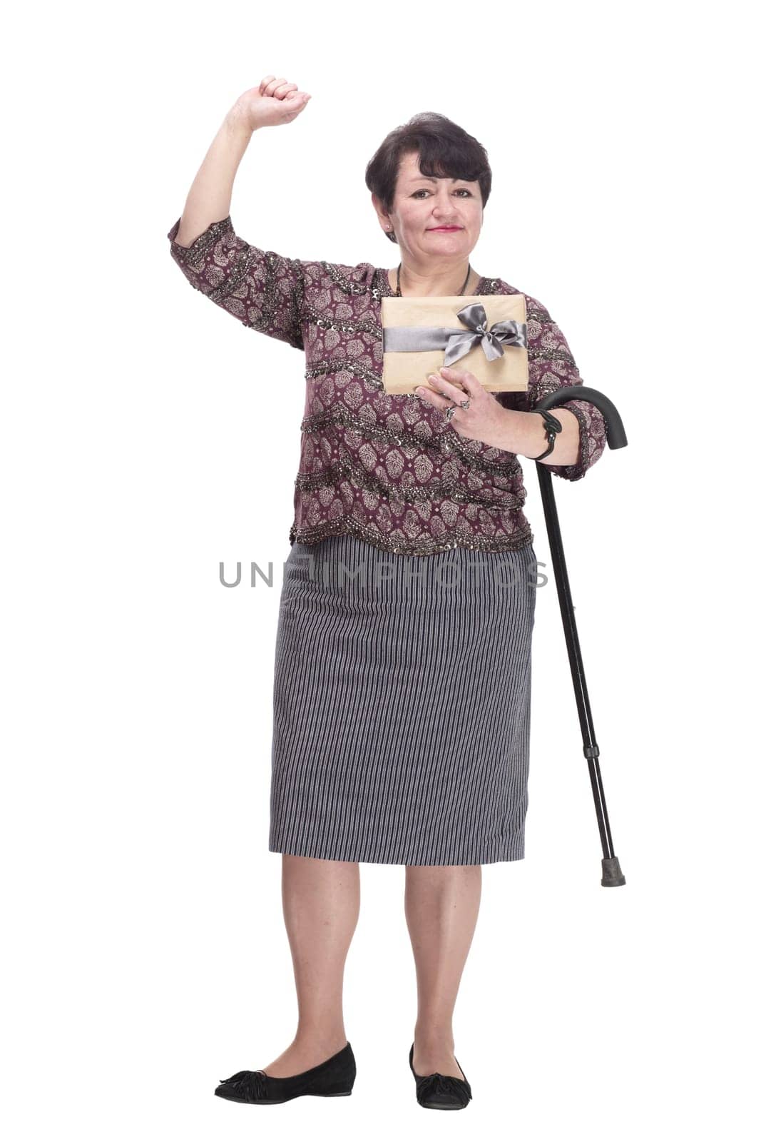 in full growth. elderly woman with a gift box. isolated on a white background.