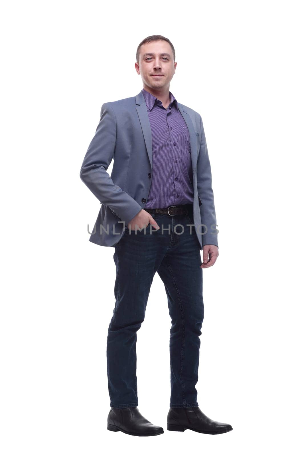 Full length portrait of a young businessman standing with his hands in the pockets and looking at camera