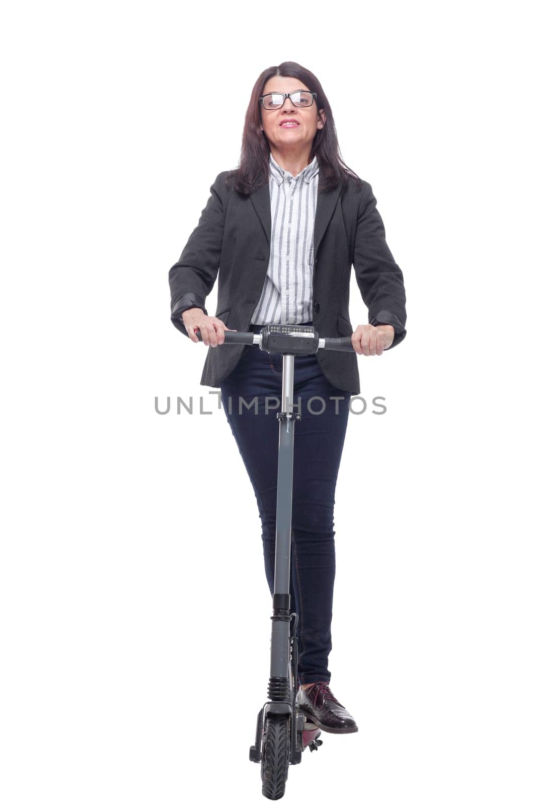 Happy beautiful woman standing near kick scooter and smiling at camera