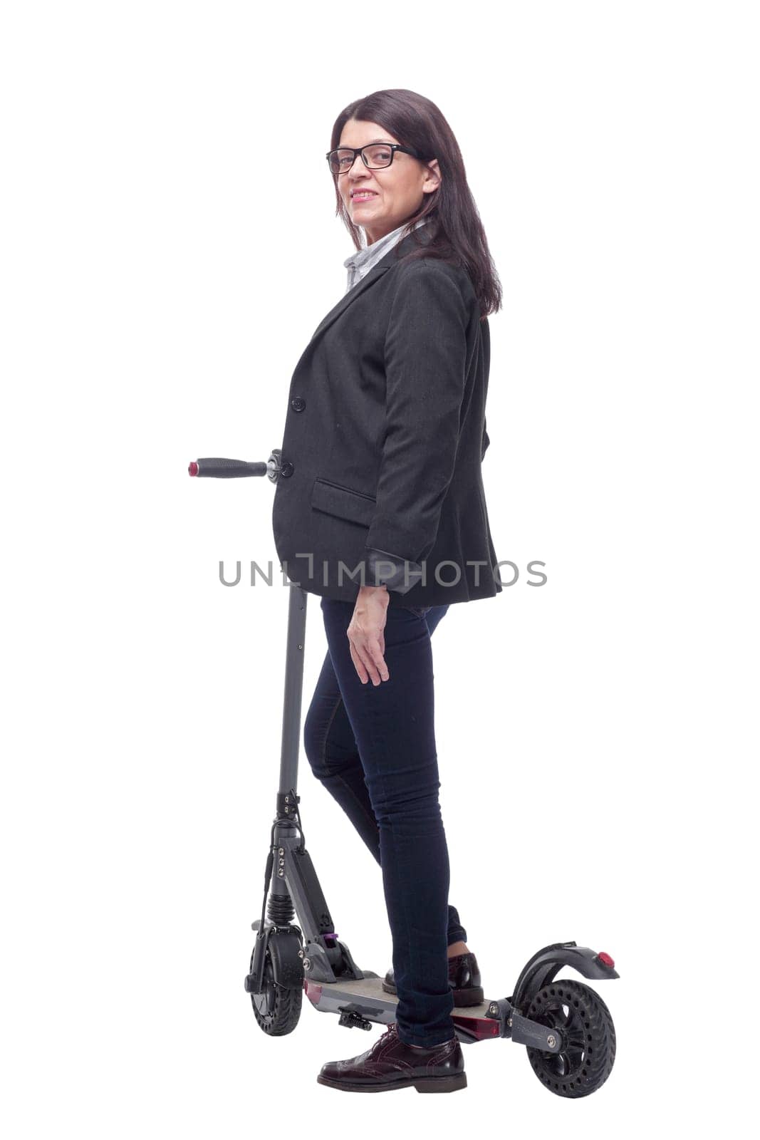 Full length portrait of a woman riding a scooter isolated on white background and pointede at camera