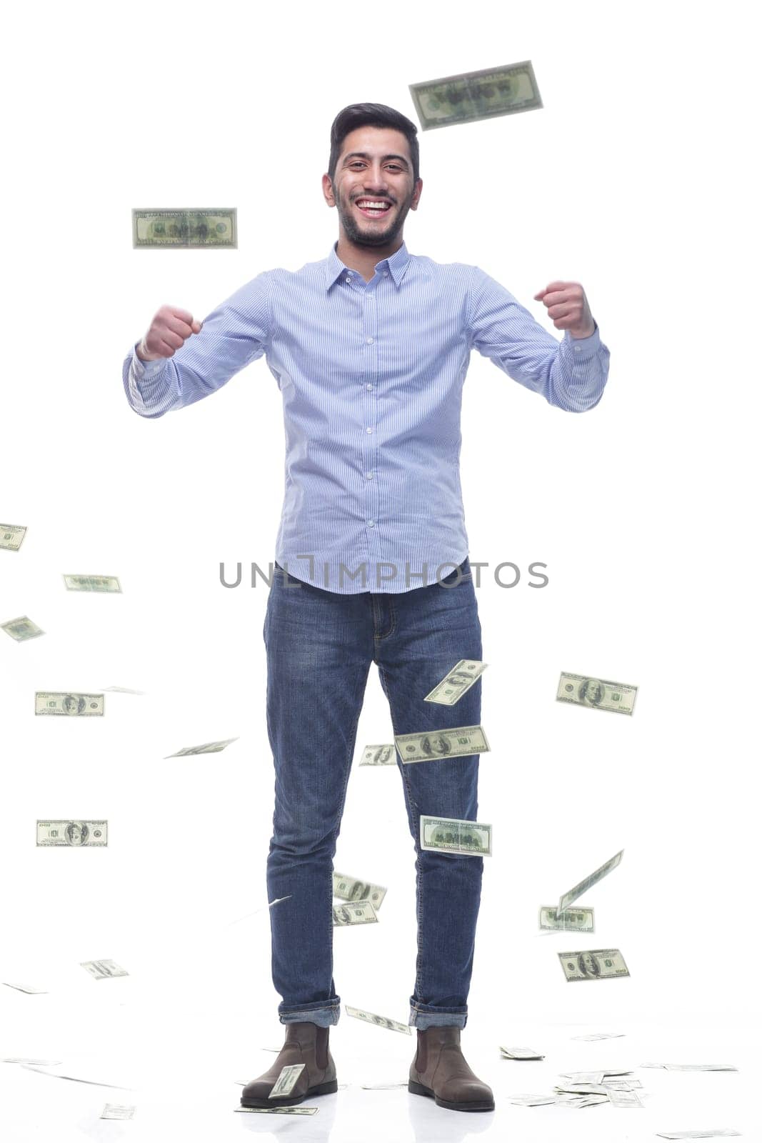 in full growth. cheerful man with banknotes . isolated on a white background.