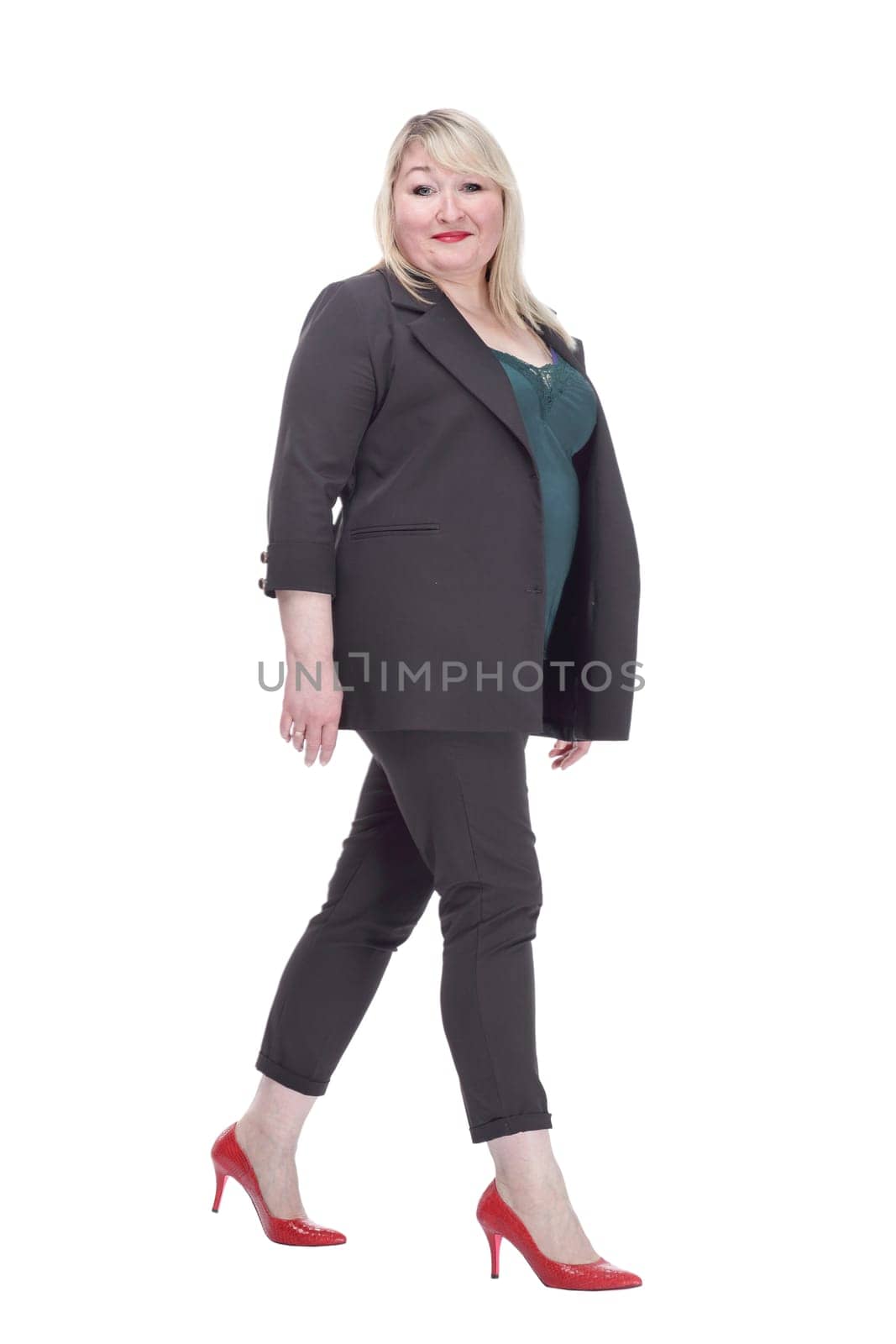 in full growth. smiling woman in a summer pantsuit striding forward. isolated on a white background.