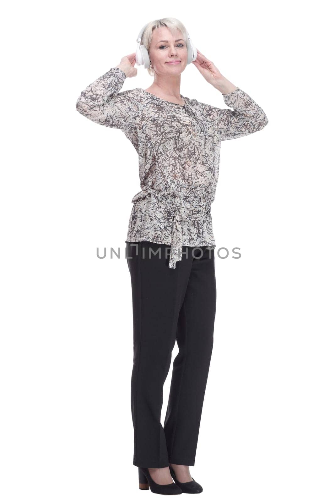 in full growth. attractive young woman listening to music through headphones . isolated on a white background.