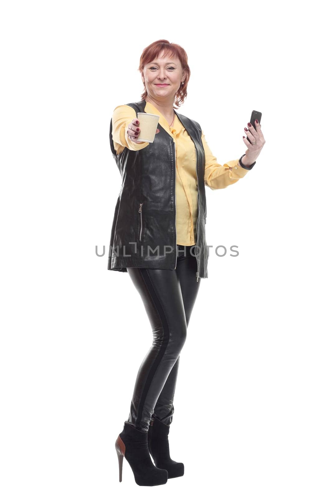 mature woman with smartphone and coffee to take away . isolated on a white background.