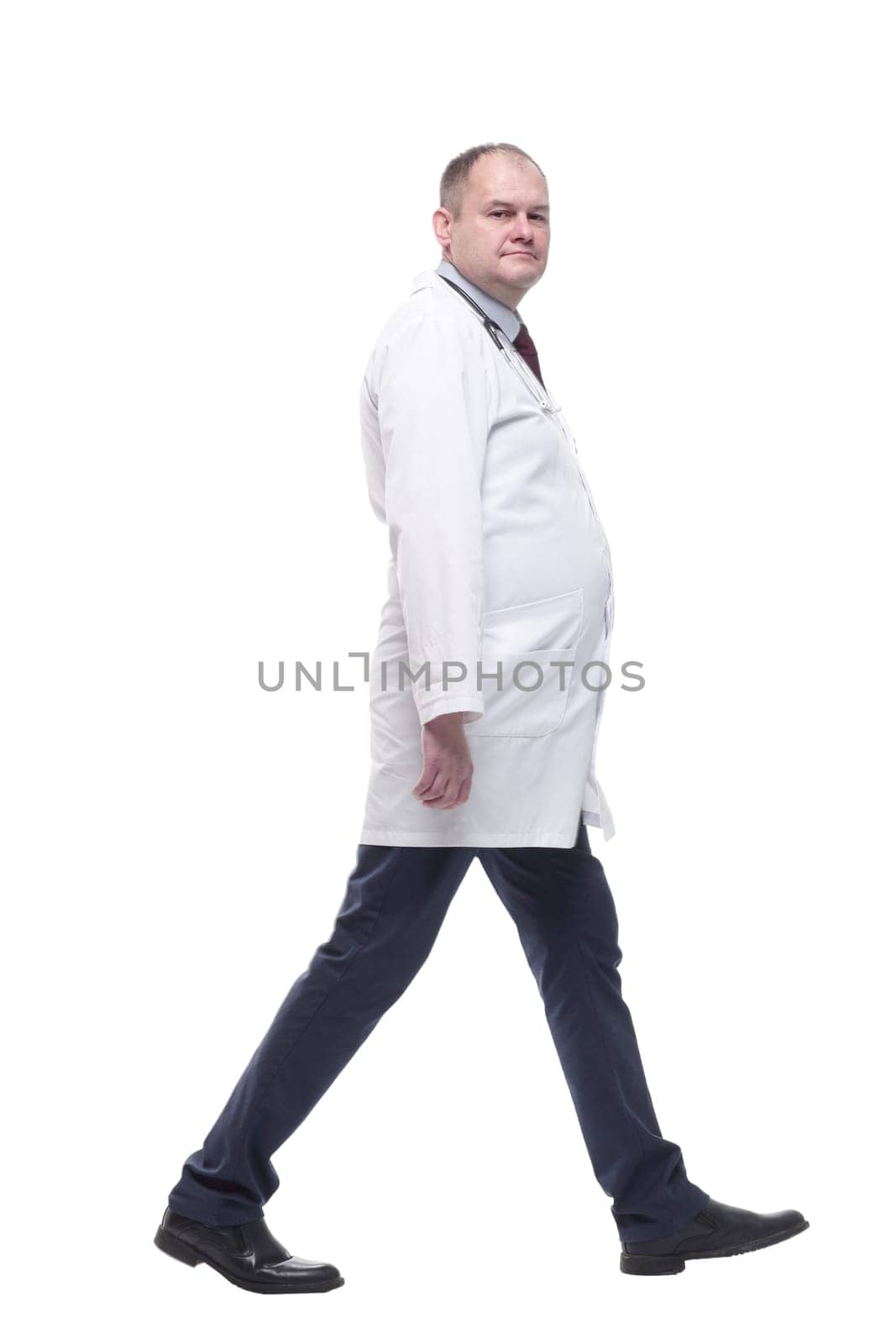 rear view. qualified male paramedic striding forward . isolated on a white background.