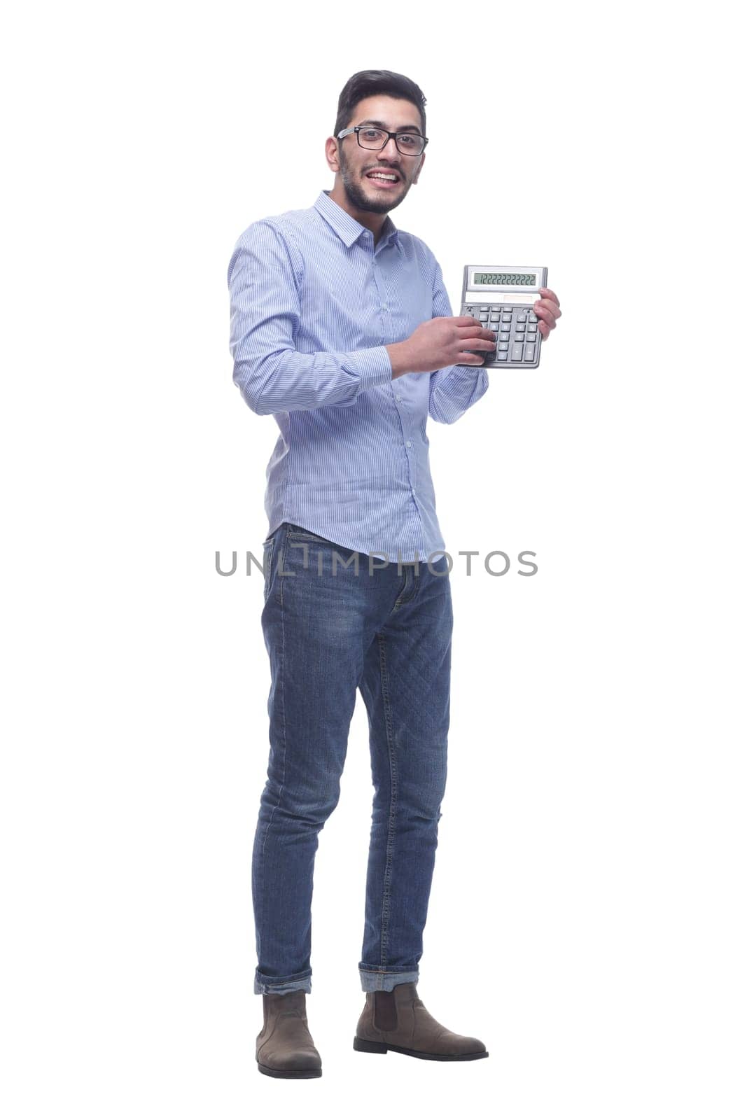 in full growth. smart young man with a calculator . isolated on a white background.