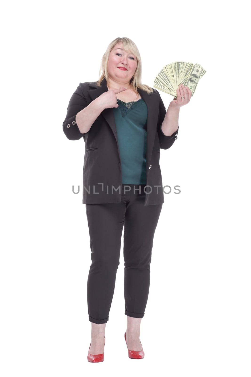 in full growth. attractive woman with a wad of banknotes. isolated on a white background.