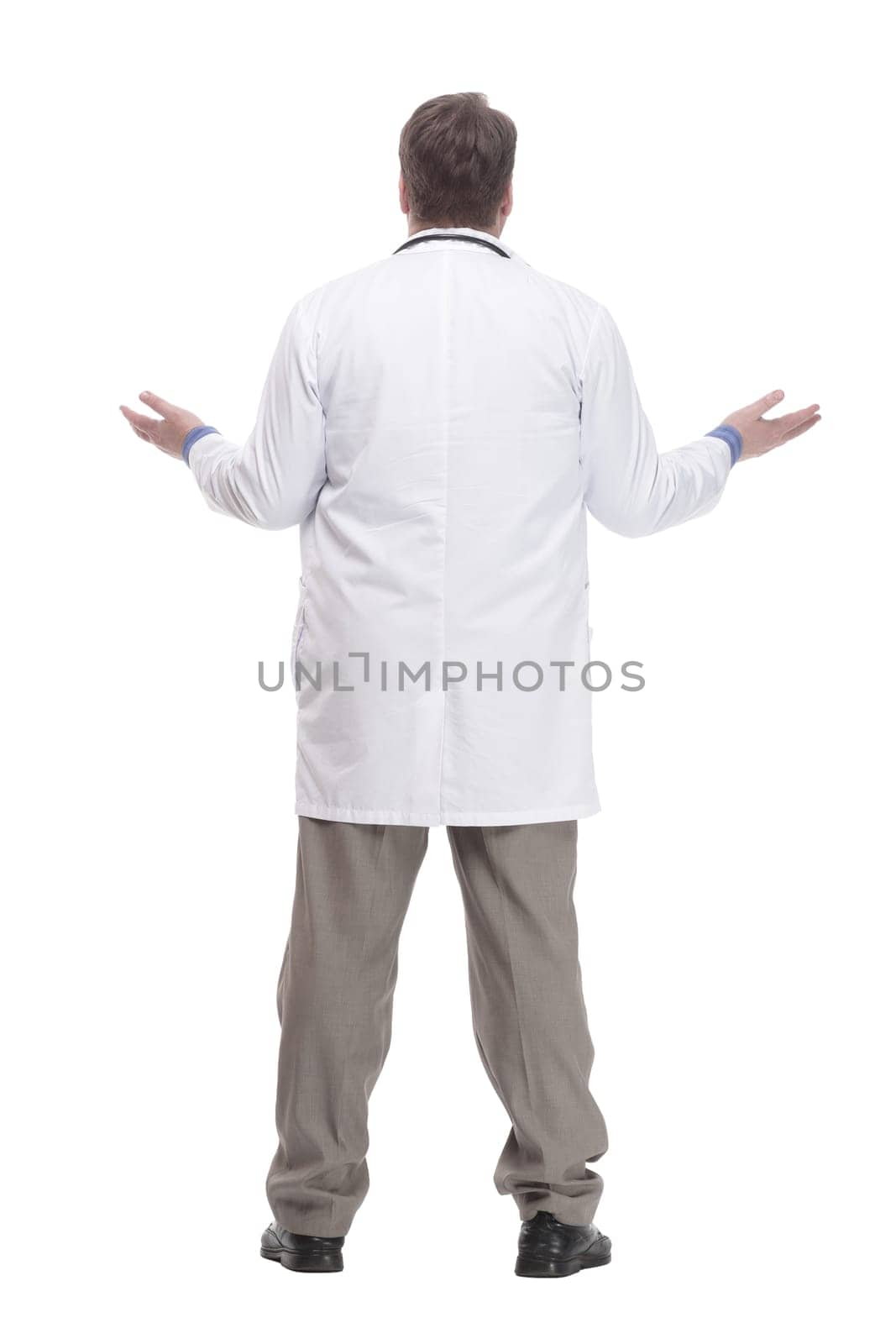in full growth. friendly doctor in a white coat.isolated on a white background