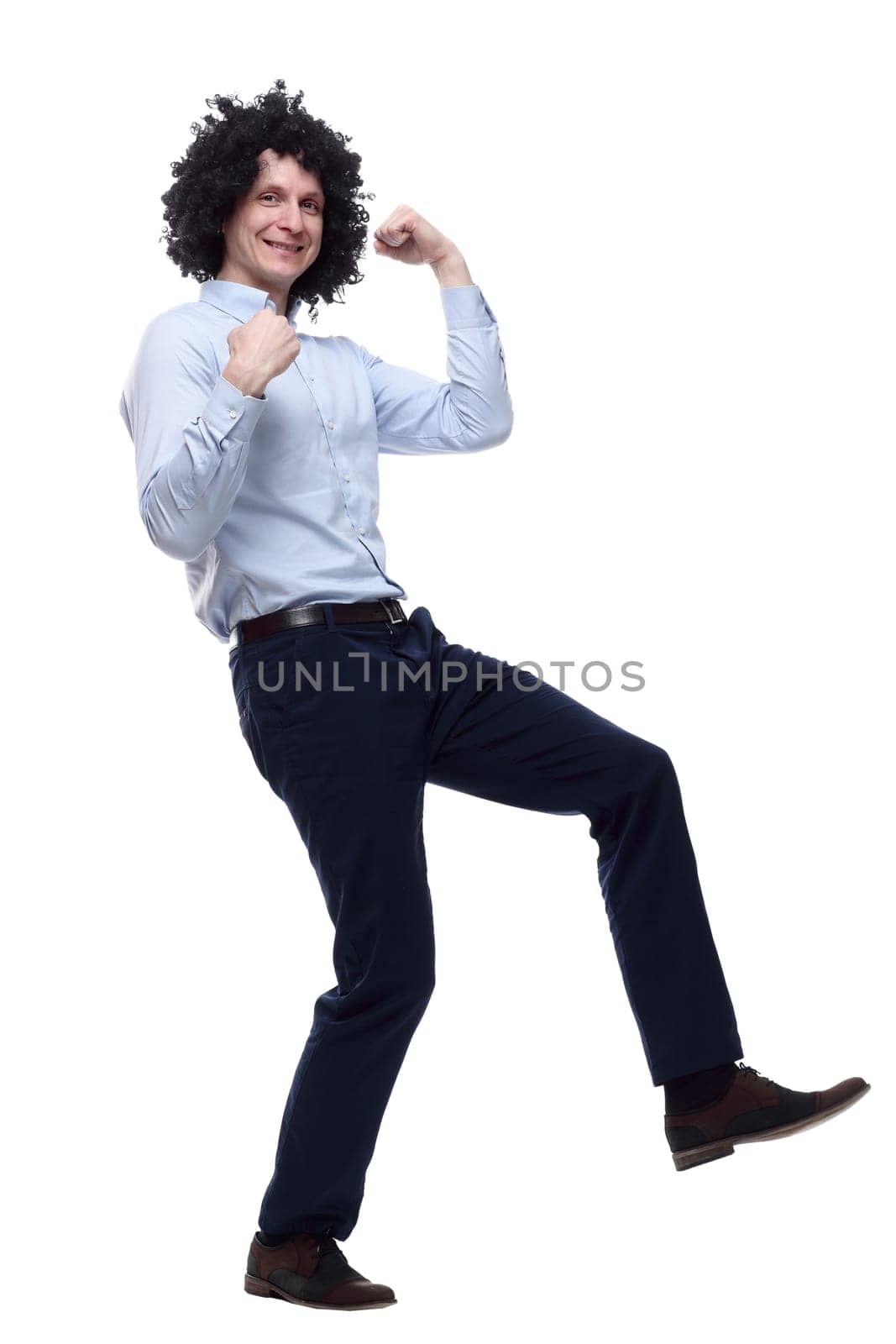 in full growth. happy curly-haired man . isolated on a white background