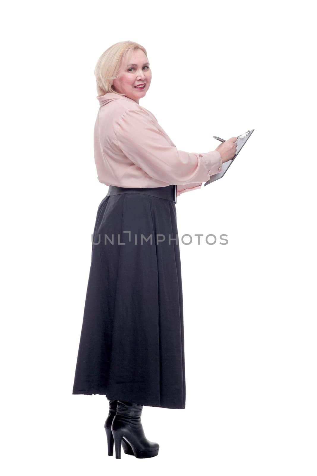 Young adult business woman standing over white background holding clipboard pointing with finger to the camera and to you, hand sign, positive and confident gesture from the front